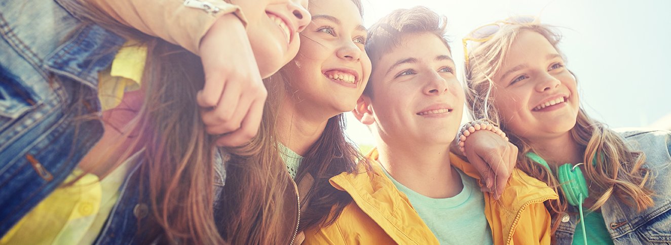 Four smiling young people