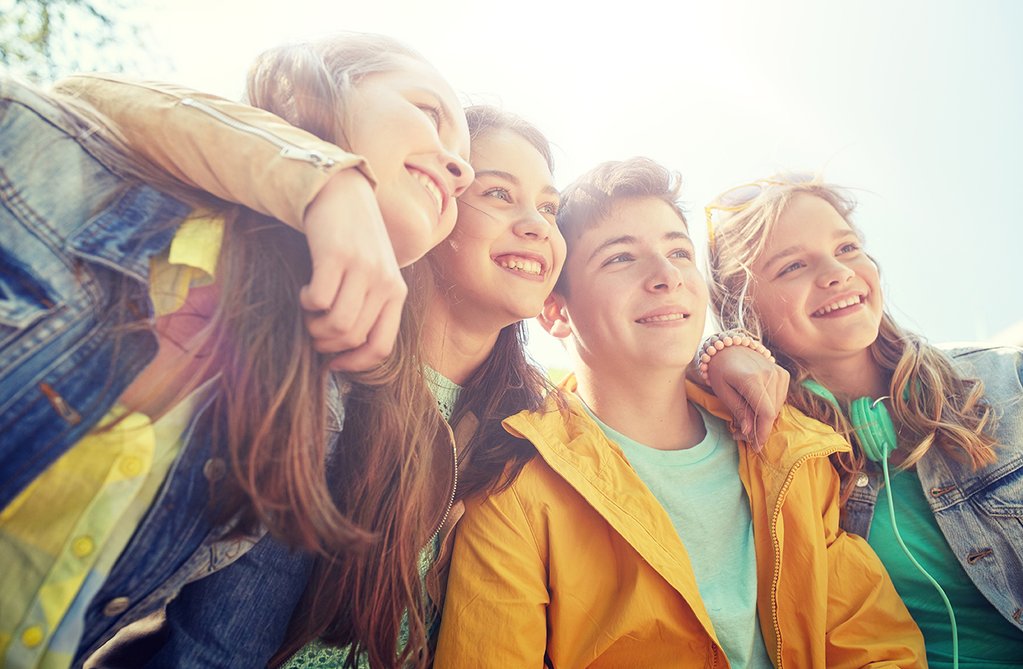 Four smiling young people