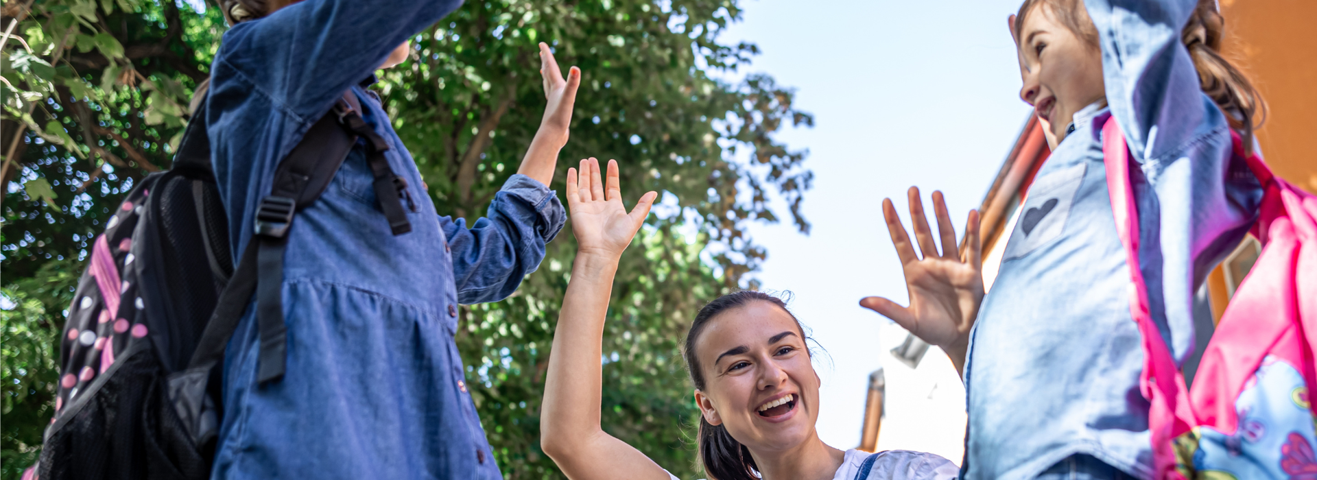 A woman high-fiving with two young girls
